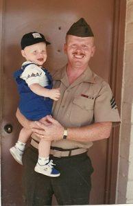Ray in uniform holding child